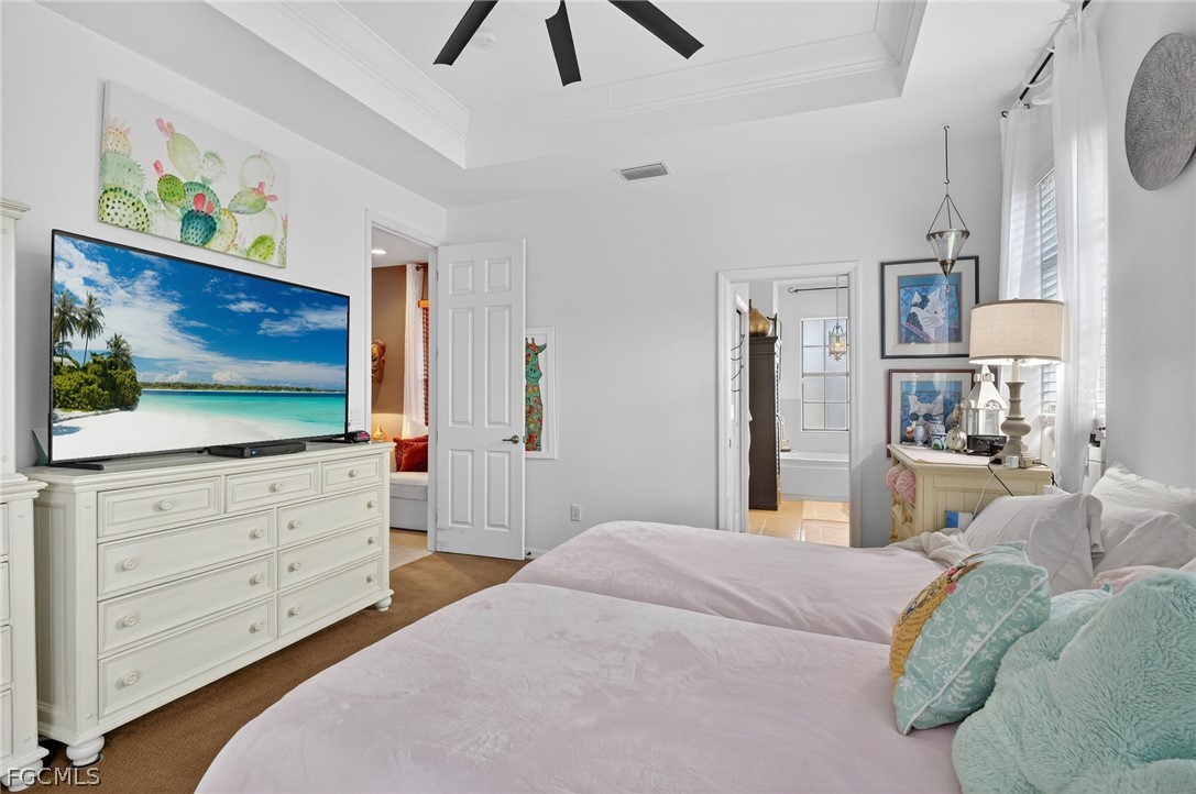 4914 Southwest 25th Court Cape Coral, FL 33914 - Photo 12 of 22 a bedroom with a bed and a flat screen tv