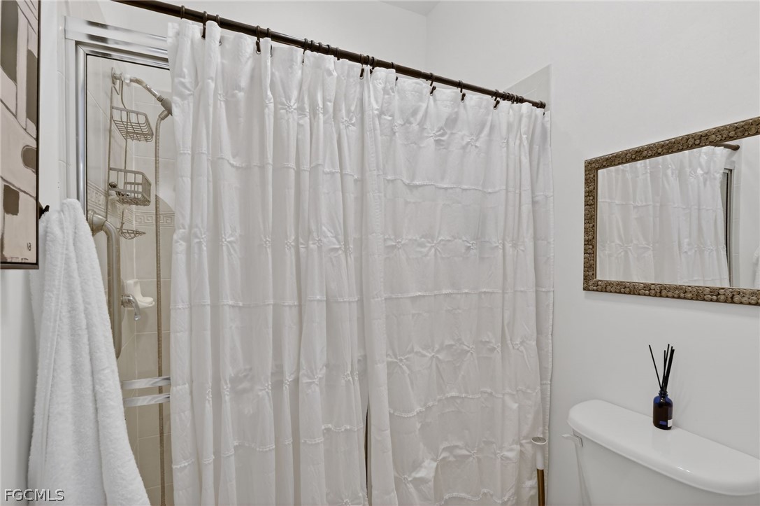 4914 Southwest 25th Court Cape Coral, FL 33914 - Photo 14 of 22 a bathroom with a shower curtain