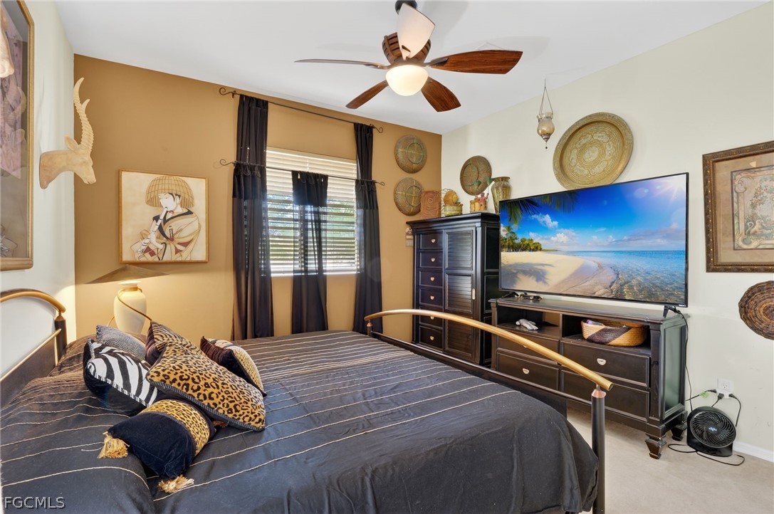 4914 Southwest 25th Court Cape Coral, FL 33914 - Photo 15 of 22 a bedroom with a bed and wooden floor