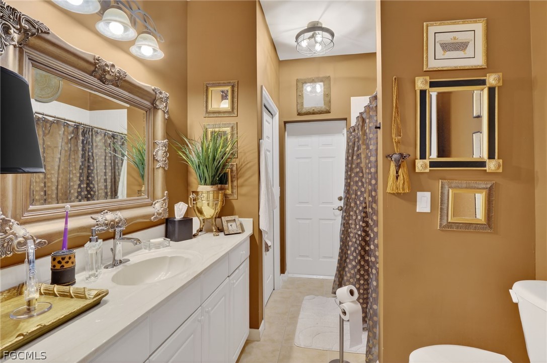 4914 Southwest 25th Court Cape Coral, FL 33914 - Photo 16 of 22 a bathroom with a granite countertop sink a mirror and a shower