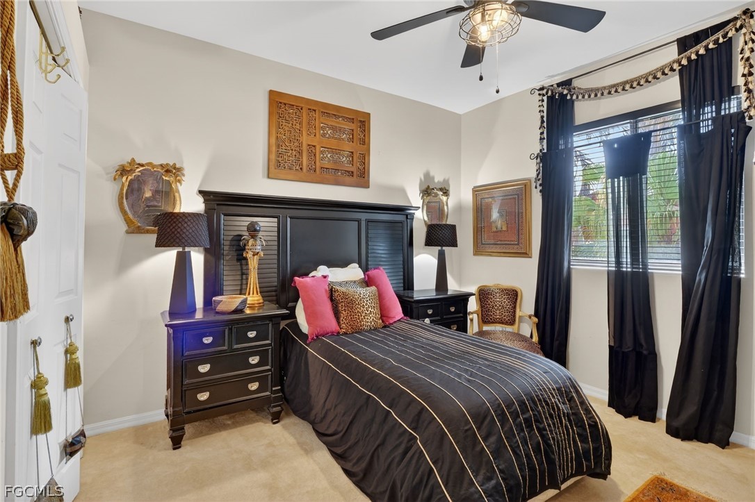 4914 Southwest 25th Court Cape Coral, FL 33914 - Photo 17 of 22 a bedroom with a bed and a chandelier