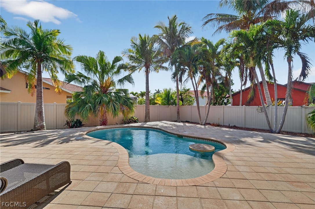 4914 Southwest 25th Court Cape Coral, FL 33914 - Photo 20 of 22 a view of a backyard with palm trees