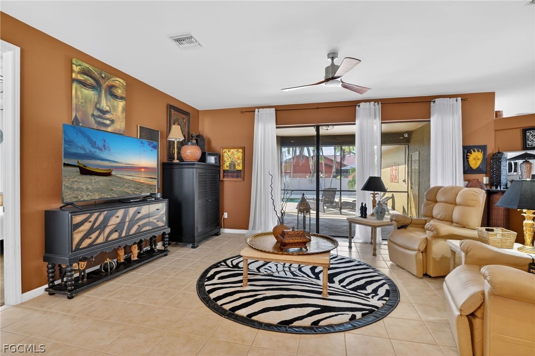 4914 Southwest 25th Court Cape Coral, FL 33914 - Photo 3 of 22 a living room with furniture and a floor to ceiling window