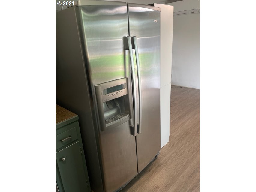 3746 Cherokee Drive Springfield, OR 97478 - Photo 13 of 26 a metallic refrigerator freezer sitting inside of a kitchen