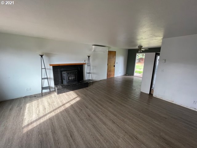 3746 Cherokee Drive Springfield, OR 97478 - Photo 6 of 26 a view of empty room with wooden floor and fireplace