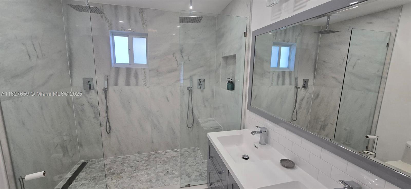 2601 Southwest 24th Avenue, Unit 2 Miami, FL 33133 - Photo 11 of 13 a bathroom with a sink a shower and a mirror