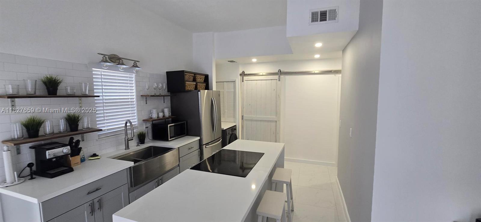 2601 Southwest 24th Avenue, Unit 2 Miami, FL 33133 - Photo 4 of 13 a room with furniture and a flat screen tv