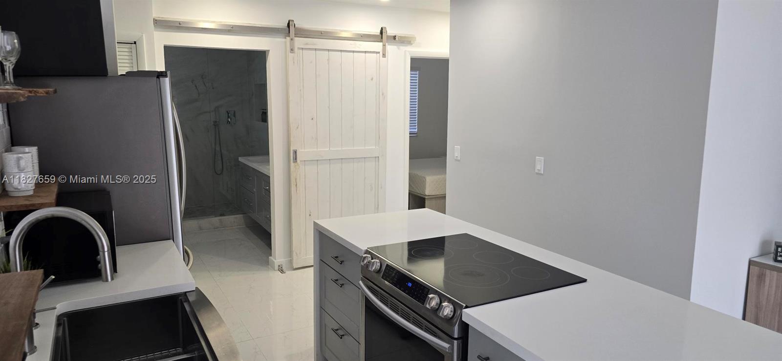 2601 Southwest 24th Avenue, Unit 2 Miami, FL 33133 - Photo 5 of 13 a kitchen with a refrigerator and a sink