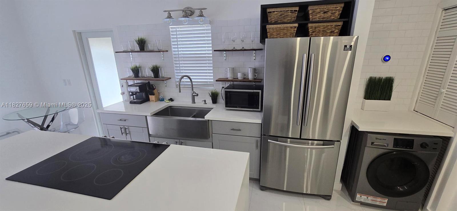 2601 Southwest 24th Avenue, Unit 2 Miami, FL 33133 - Photo 6 of 13 a kitchen with stainless steel appliances a refrigerator sink and cabinets
