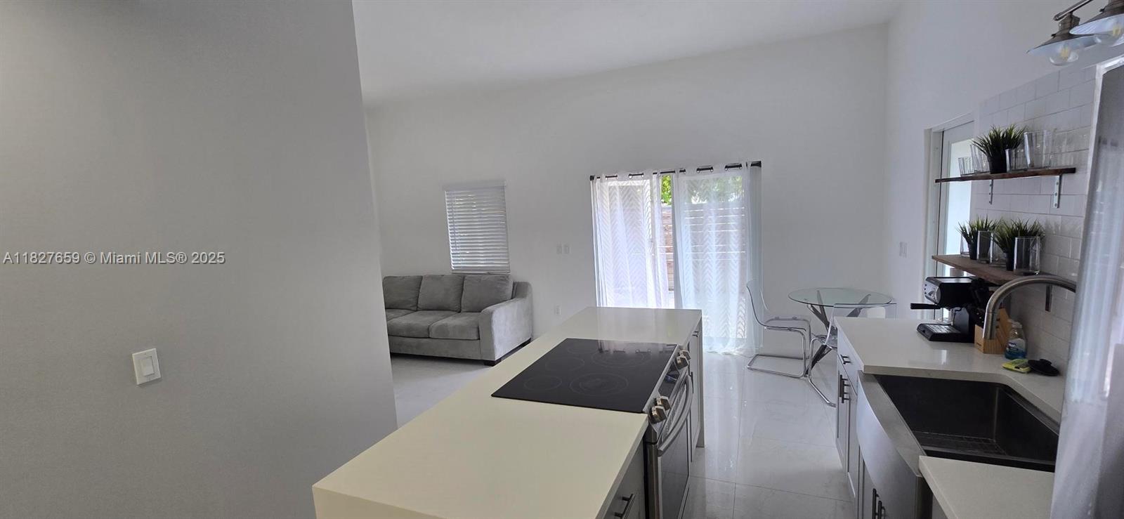 2601 Southwest 24th Avenue, Unit 2 Miami, FL 33133 - Photo 7 of 13 a living room with furniture and a flat screen tv