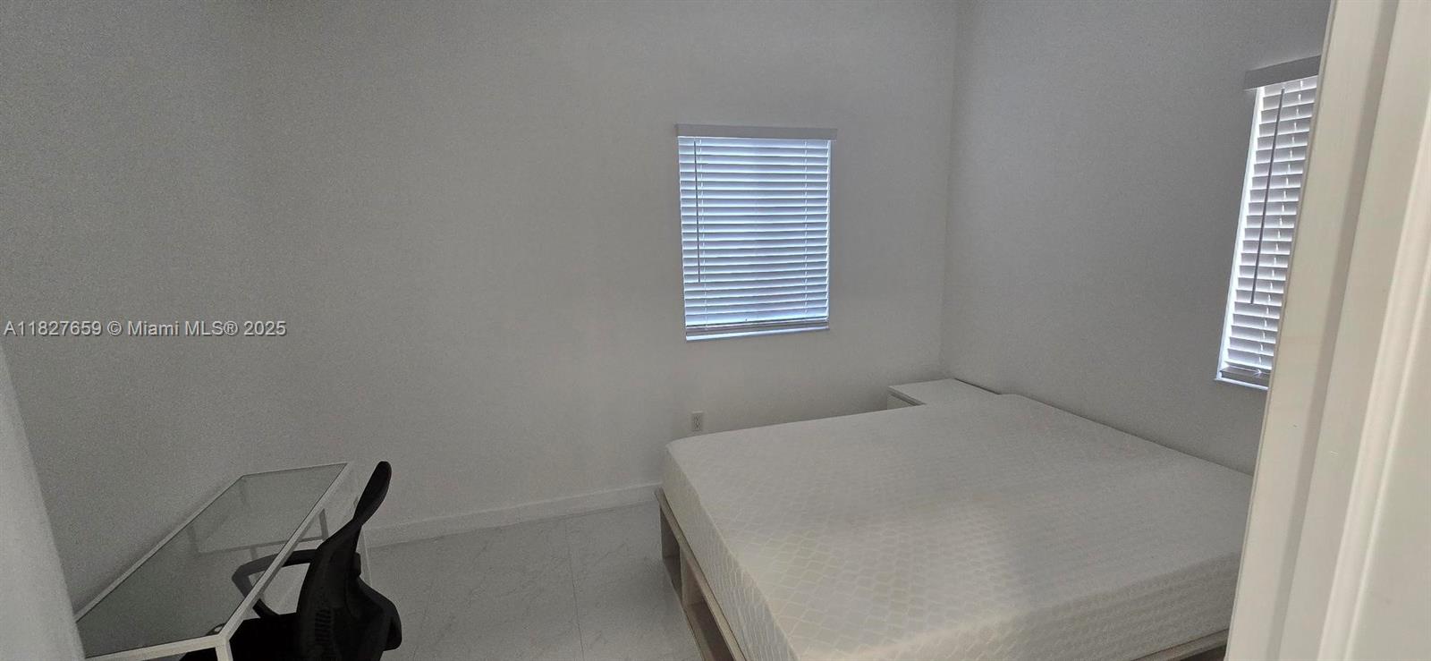 2601 Southwest 24th Avenue, Unit 2 Miami, FL 33133 - Photo 9 of 13 a bedroom with a bed and a window