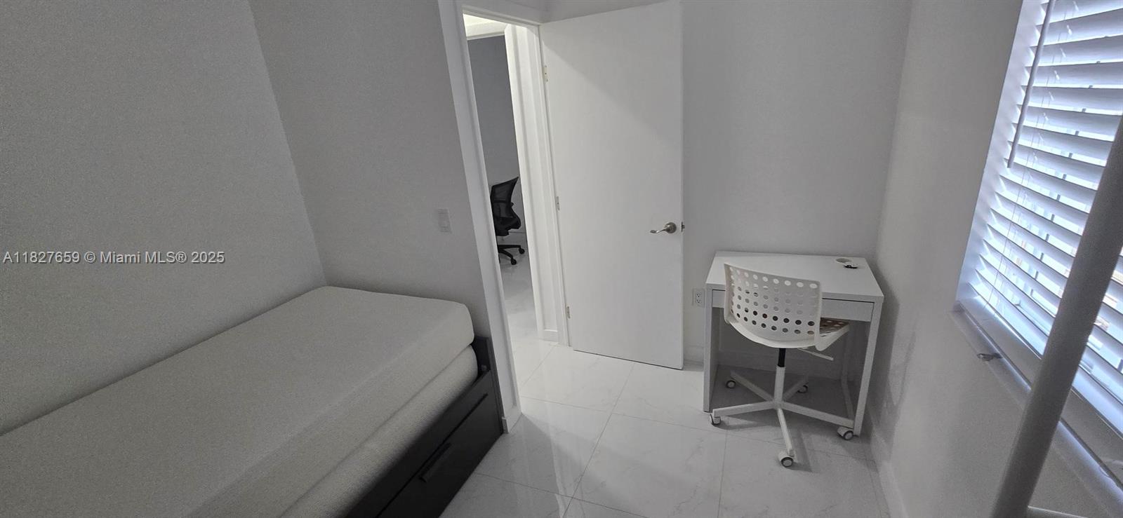 2601 Southwest 24th Avenue, Unit 2 Miami, FL 33133 - Photo 10 of 13 a bedroom with a bed and a chair in it