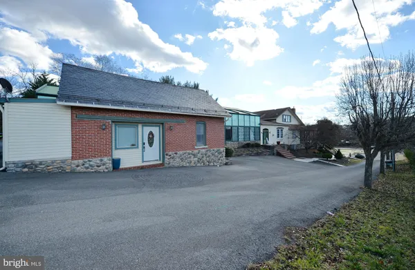 a living room with stainless steel appliances kitchen island granite countertop furniture and a view of kitchen