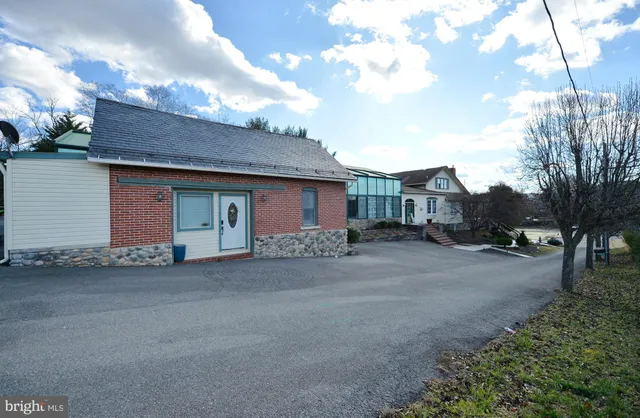 a living room with stainless steel appliances kitchen island granite countertop furniture and a view of kitchen