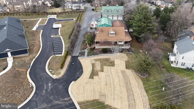 an aerial view of a swimming pool with outdoor seating