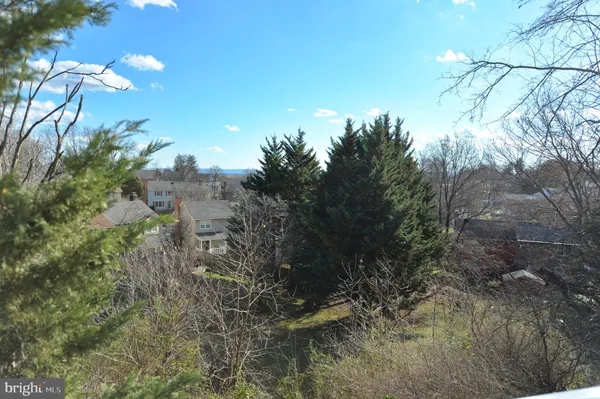 a view of an empty room with window and cabinet