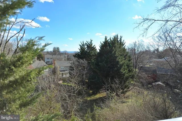 a view of an empty room with window and cabinet