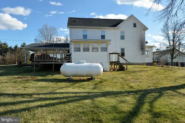 a front view of a house with a yard and table and chairs
