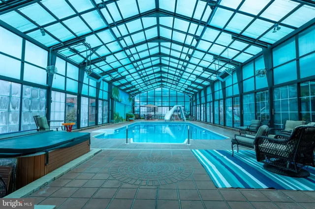 a view of swimming pool with outdoor seating and a patio