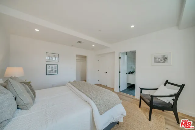 a bedroom with a bed and a chair