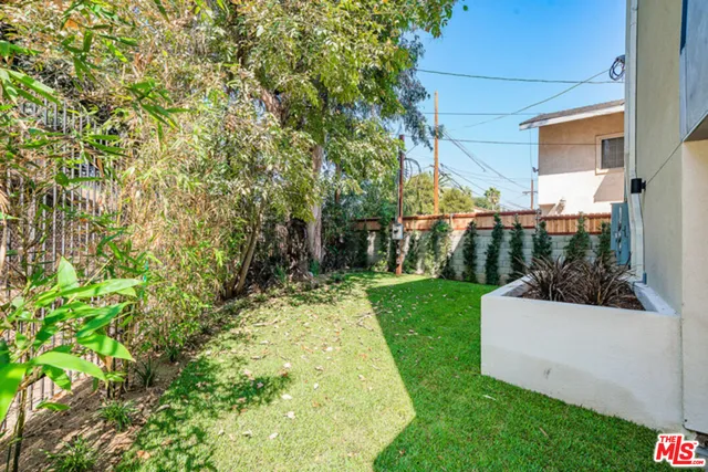 a view of a back yard of the house and front view of a house