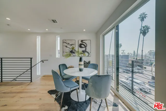 a dining room with furniture and wooden floor