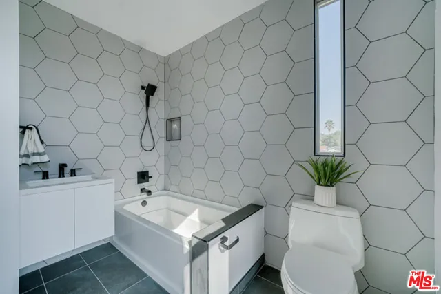 a bathroom with a sink a toilet and a bathtub