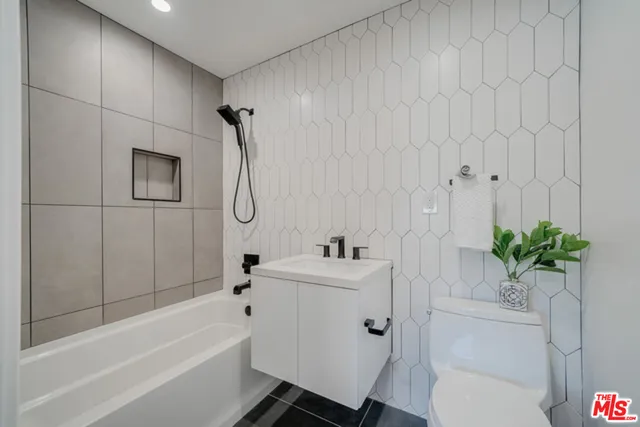 a bathroom with a sink a bath tub and a shower