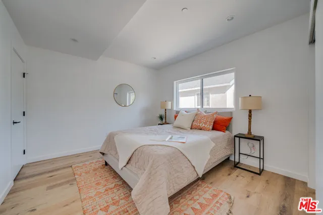 a bedroom with a bed and a lamp on table