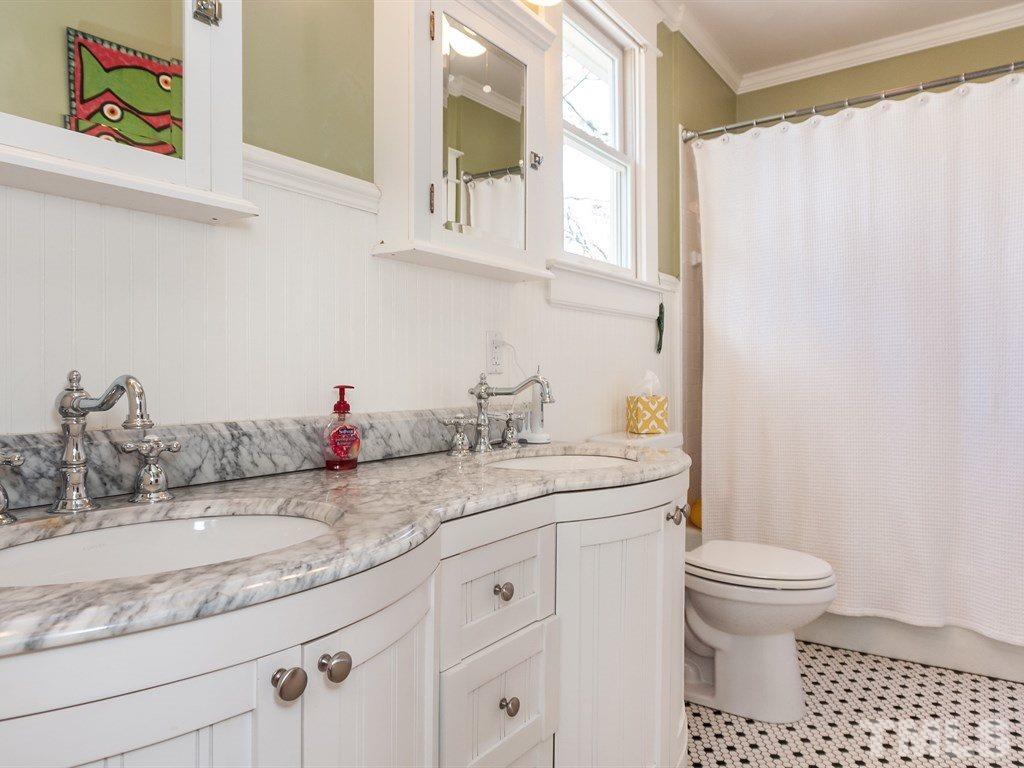 3400 Ruffin Street Raleigh, NC 27607 - Photo 13 of 21 a bathroom with a granite countertop sink a toilet and a mirror