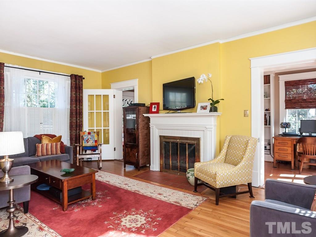 3400 Ruffin Street Raleigh, NC 27607 - Photo 4 of 21 a living room with furniture a flat screen tv and a fireplace