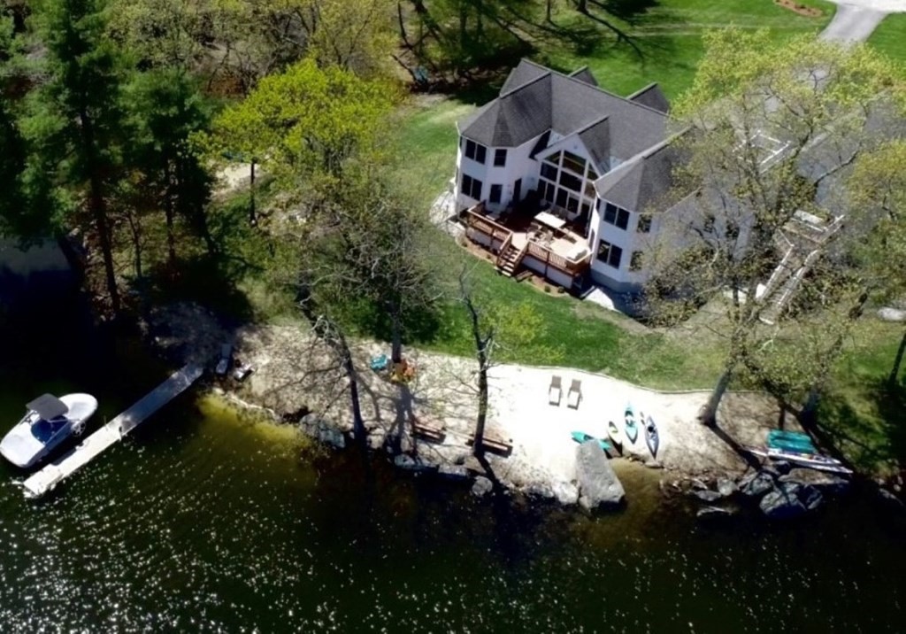 an aerial view of a house with a yard basket ball court and outdoor seating