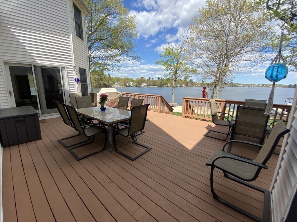 10 Cedar Lane Tyngsborough, MA 01879 - Photo 12 of 42 a view of a roof deck with table and chairs and wooden floor