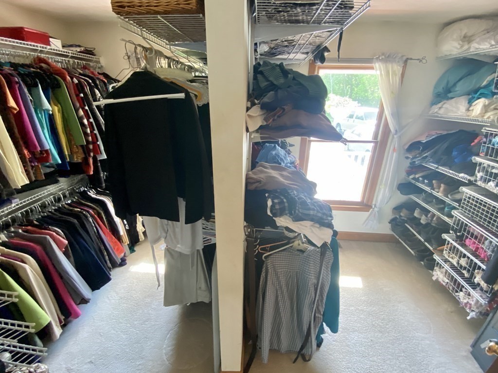 10 Cedar Lane Tyngsborough, MA 01879 - Photo 17 of 42 a view of walk in closet with clothes and shoes