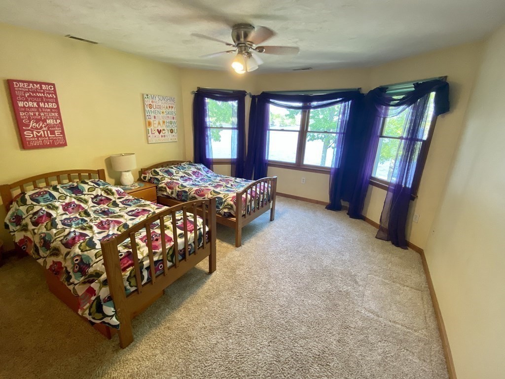 10 Cedar Lane Tyngsborough, MA 01879 - Photo 28 of 42 a bed sitting in a spacious bedroom next to a window