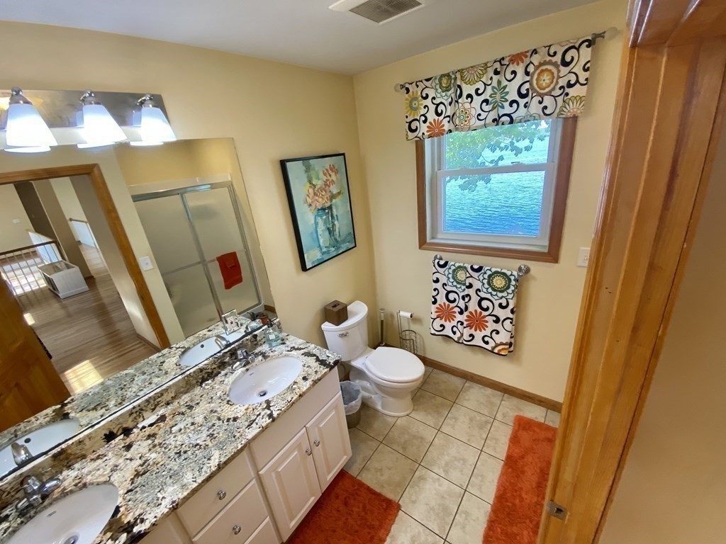 10 Cedar Lane Tyngsborough, MA 01879 - Photo 30 of 42 a bathroom with a granite countertop toilet sink and mirror