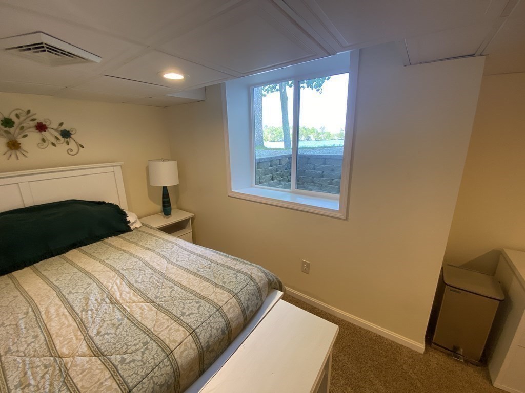 10 Cedar Lane Tyngsborough, MA 01879 - Photo 37 of 42 a bedroom with a bed and a potted plant