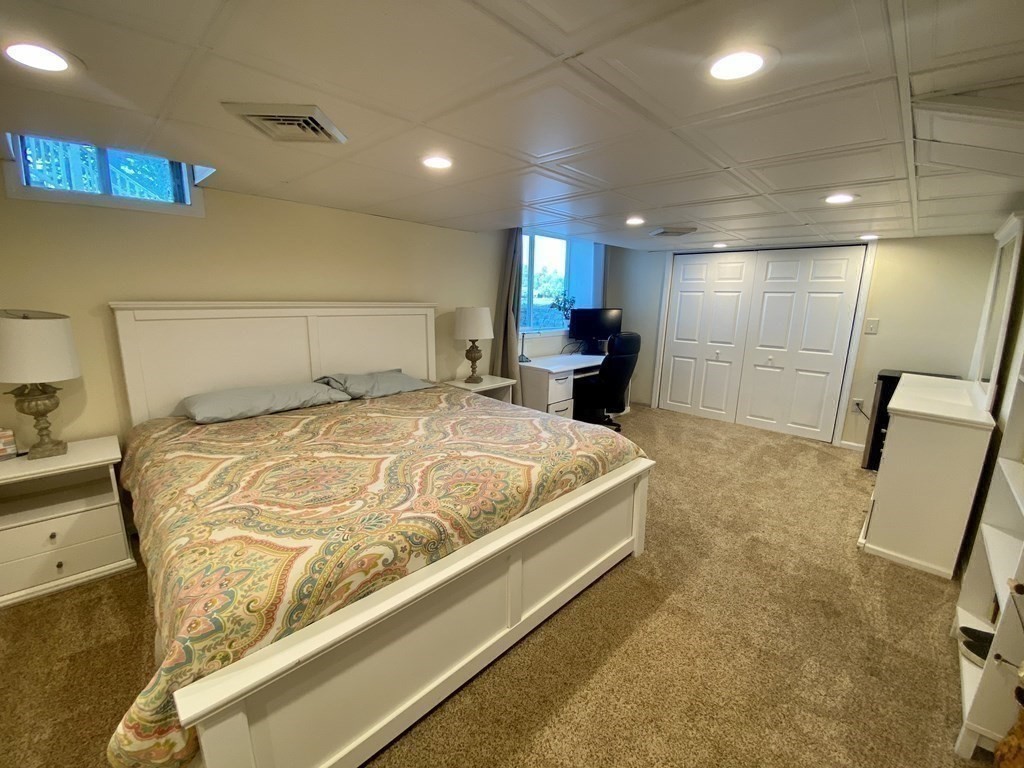 10 Cedar Lane Tyngsborough, MA 01879 - Photo 38 of 42 a large bedroom with a bed and a mirror in it