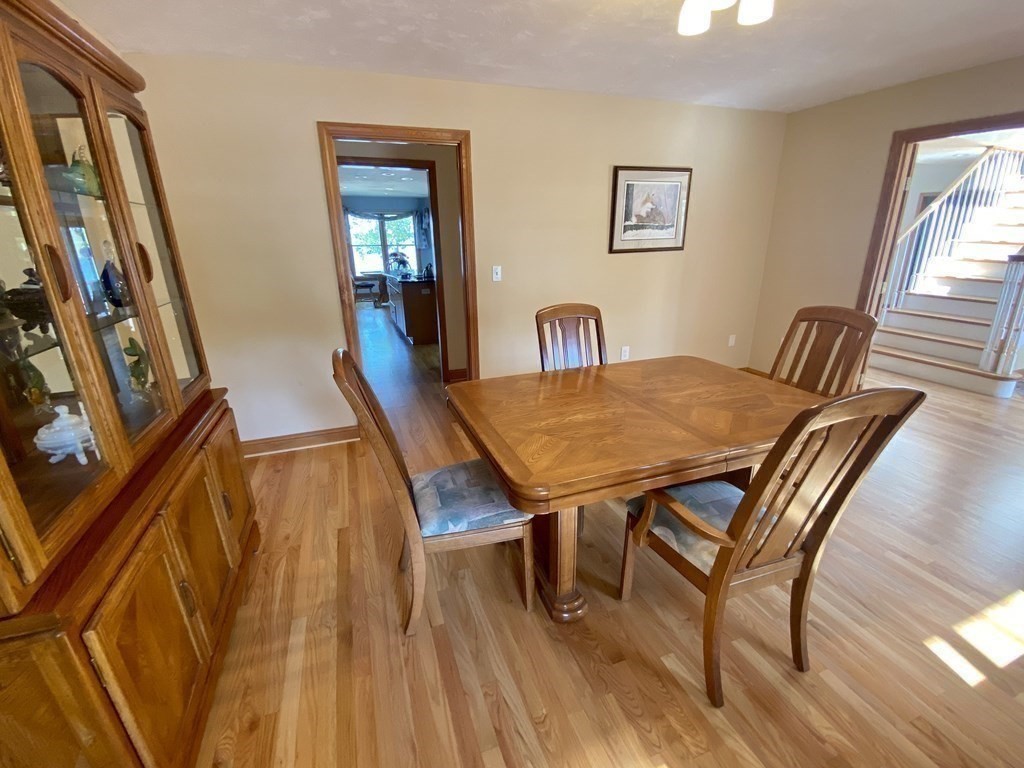 10 Cedar Lane Tyngsborough, MA 01879 - Photo 9 of 42 a view of a dining room with furniture and wooden floor