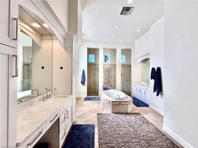 a large bathroom with a sink a large mirror and a toilet