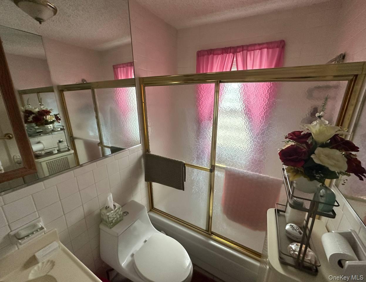 191-53 115th Road Queens, NY 11412 - Photo 15 of 16 a bathroom with a sink mirror vanity and toilet