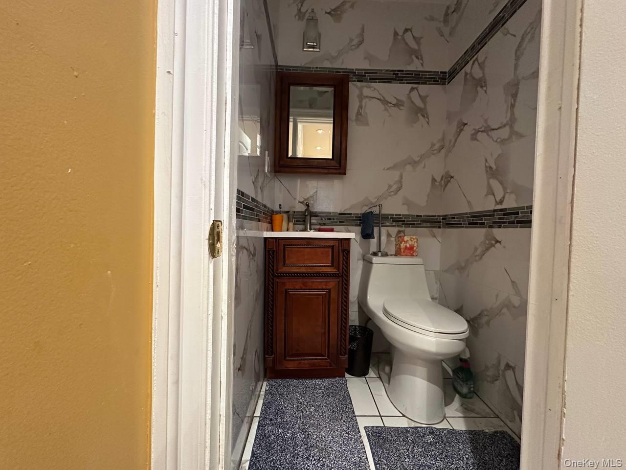 191-53 115th Road Queens, NY 11412 - Photo 16 of 16 a bathroom with a toilet and a sink