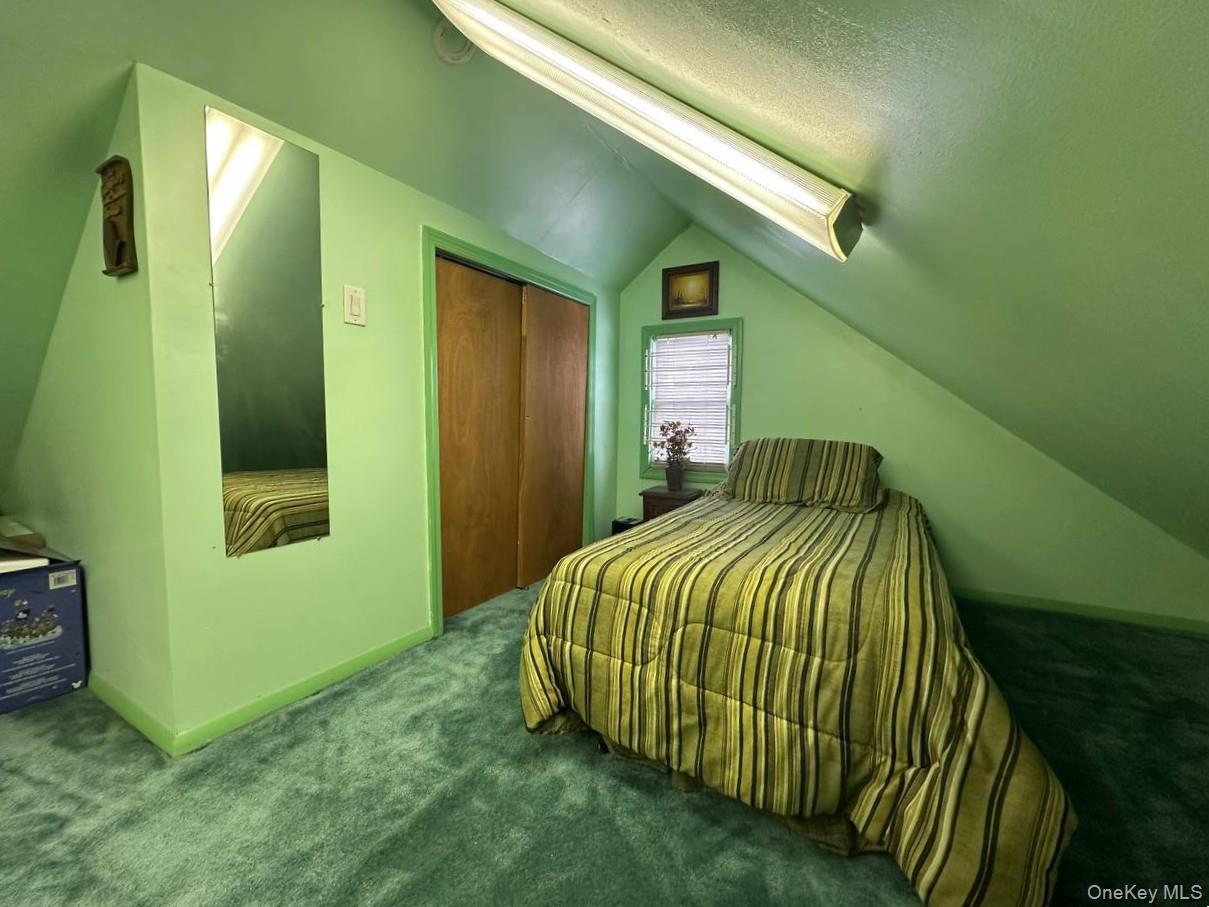 191-53 115th Road Queens, NY 11412 - Photo 10 of 16 a bedroom with a bed and a mirror