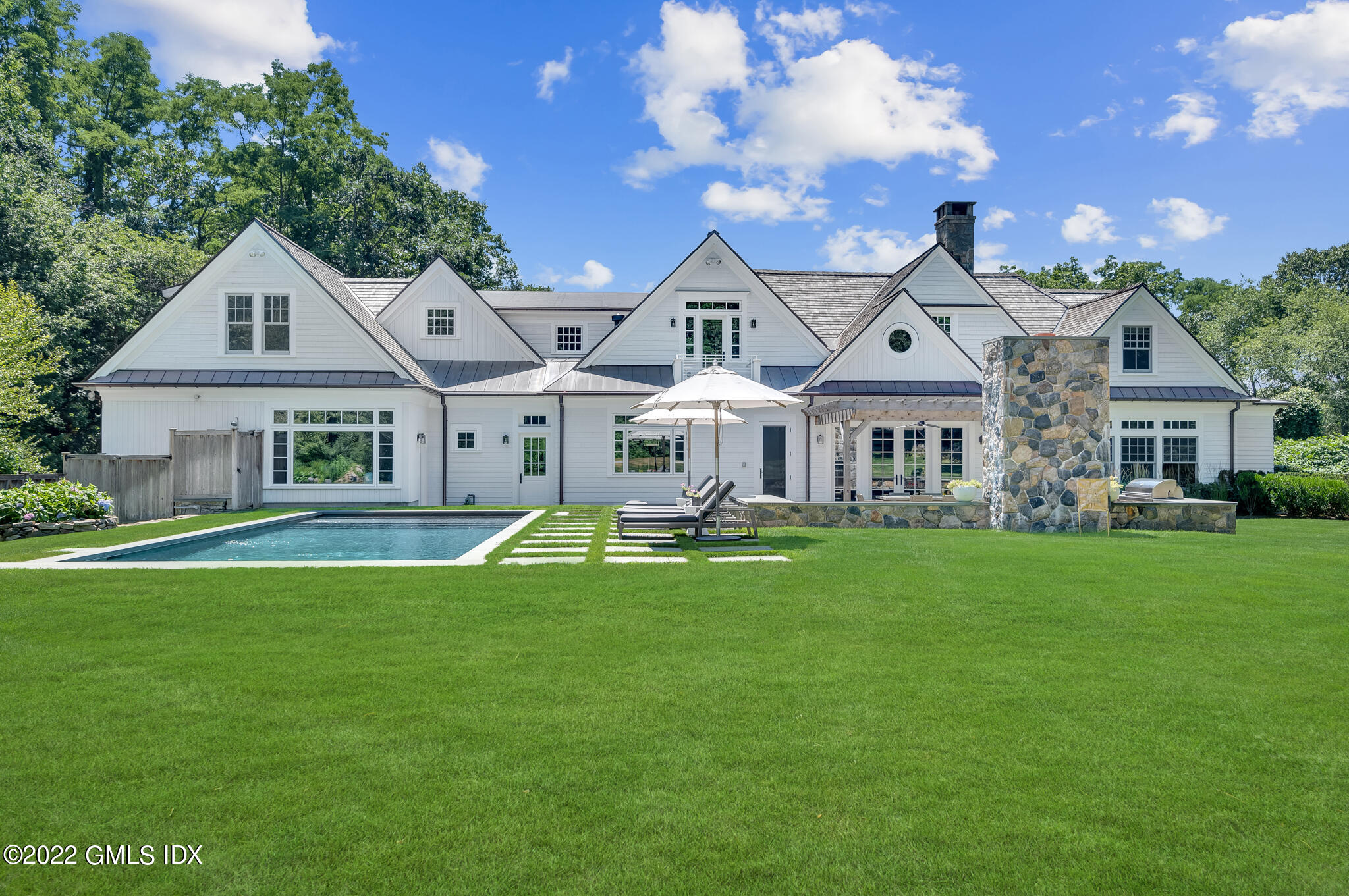 269 Riversville Road Greenwich, CT 06831 - Photo 2 of 55 a front view of a house with a garden