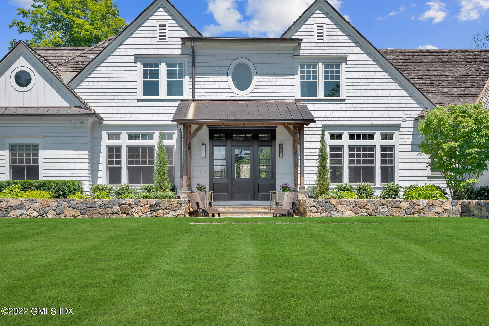 269 Riversville Road Greenwich, CT 06831 - Photo 3 of 55 a front view of a house with garden