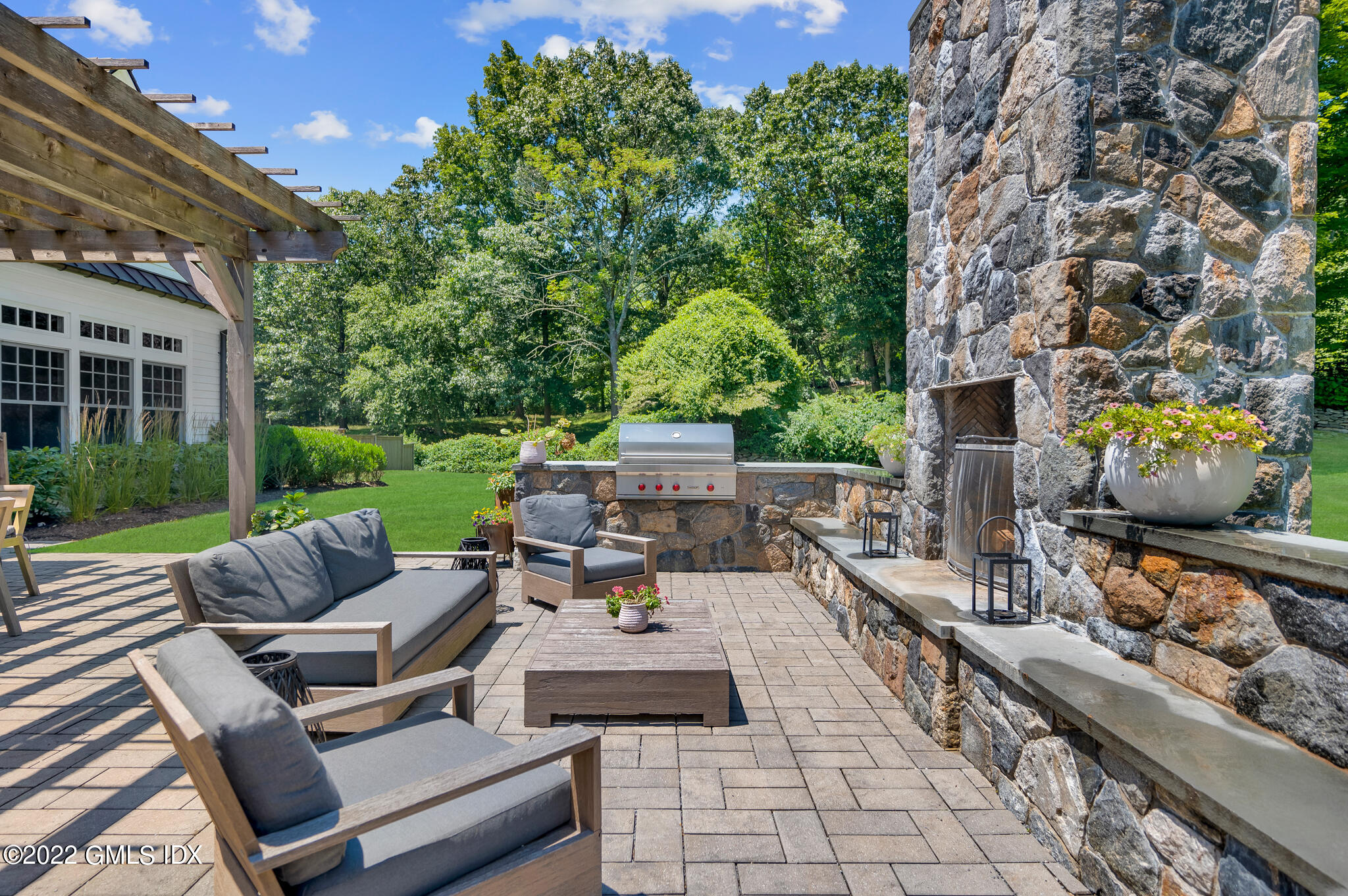 269 Riversville Road Greenwich, CT 06831 - Photo 36 of 55 a view of a patio with couches table and chairs with a yard