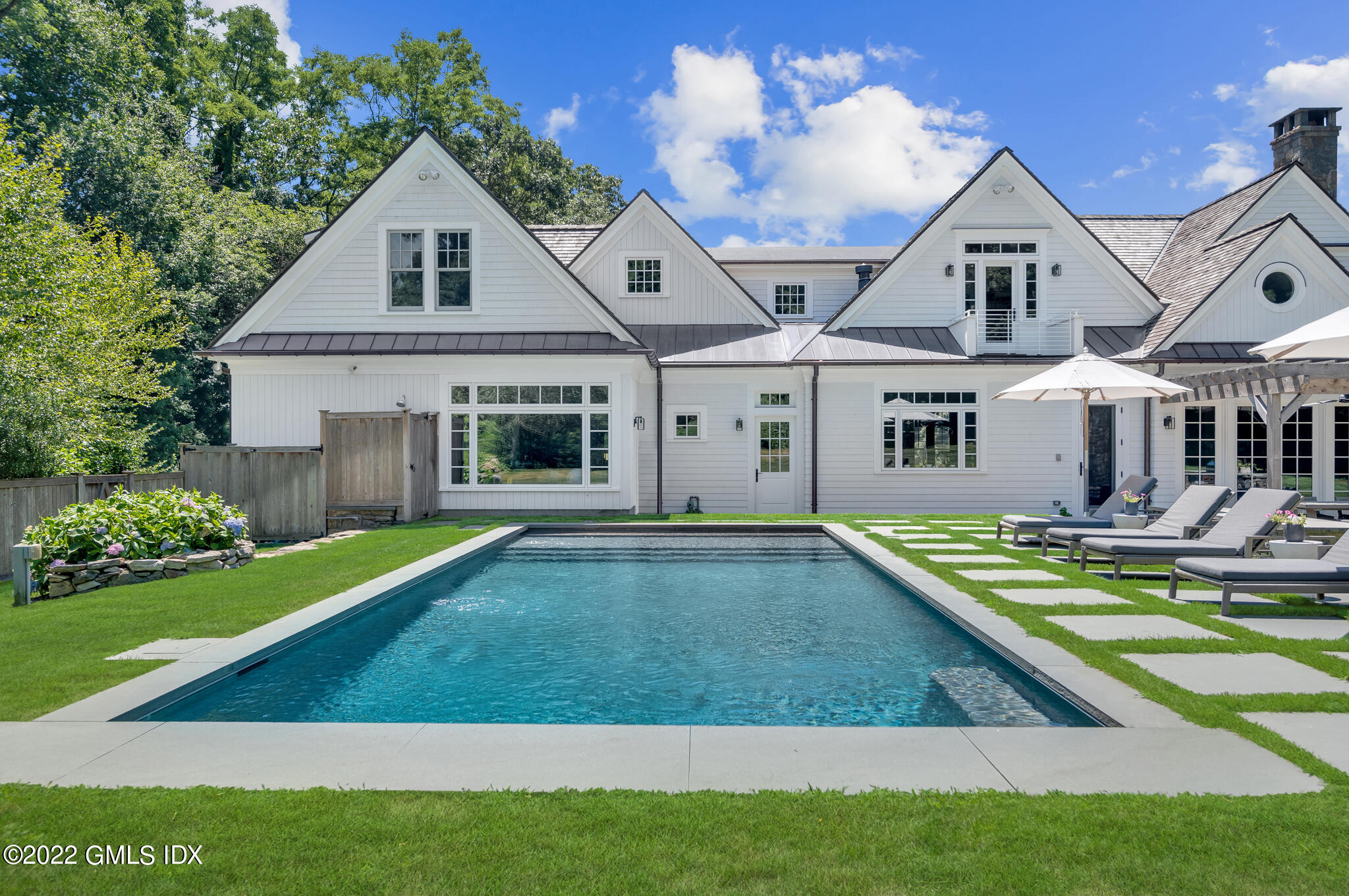 269 Riversville Road Greenwich, CT 06831 - Photo 39 of 55 a view of a white house with a big yard and potted plants