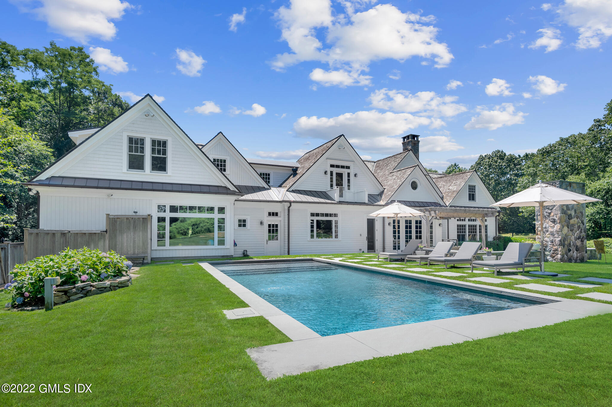 269 Riversville Road Greenwich, CT 06831 - Photo 40 of 55 a front view of a house with a yard