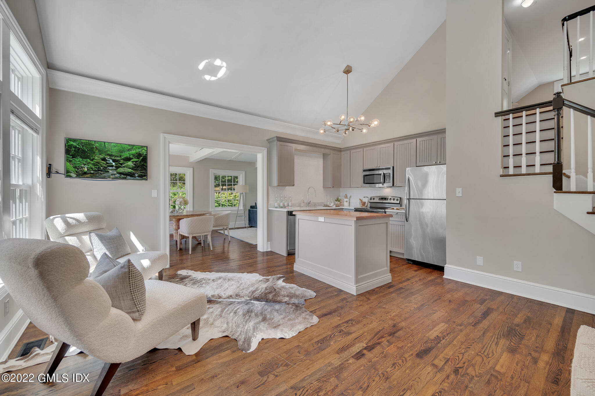 269 Riversville Road Greenwich, CT 06831 - Photo 44 of 55 a kitchen with stainless steel appliances granite countertop a refrigerator a sink dishwasher a stove and a dining table with wooden floor