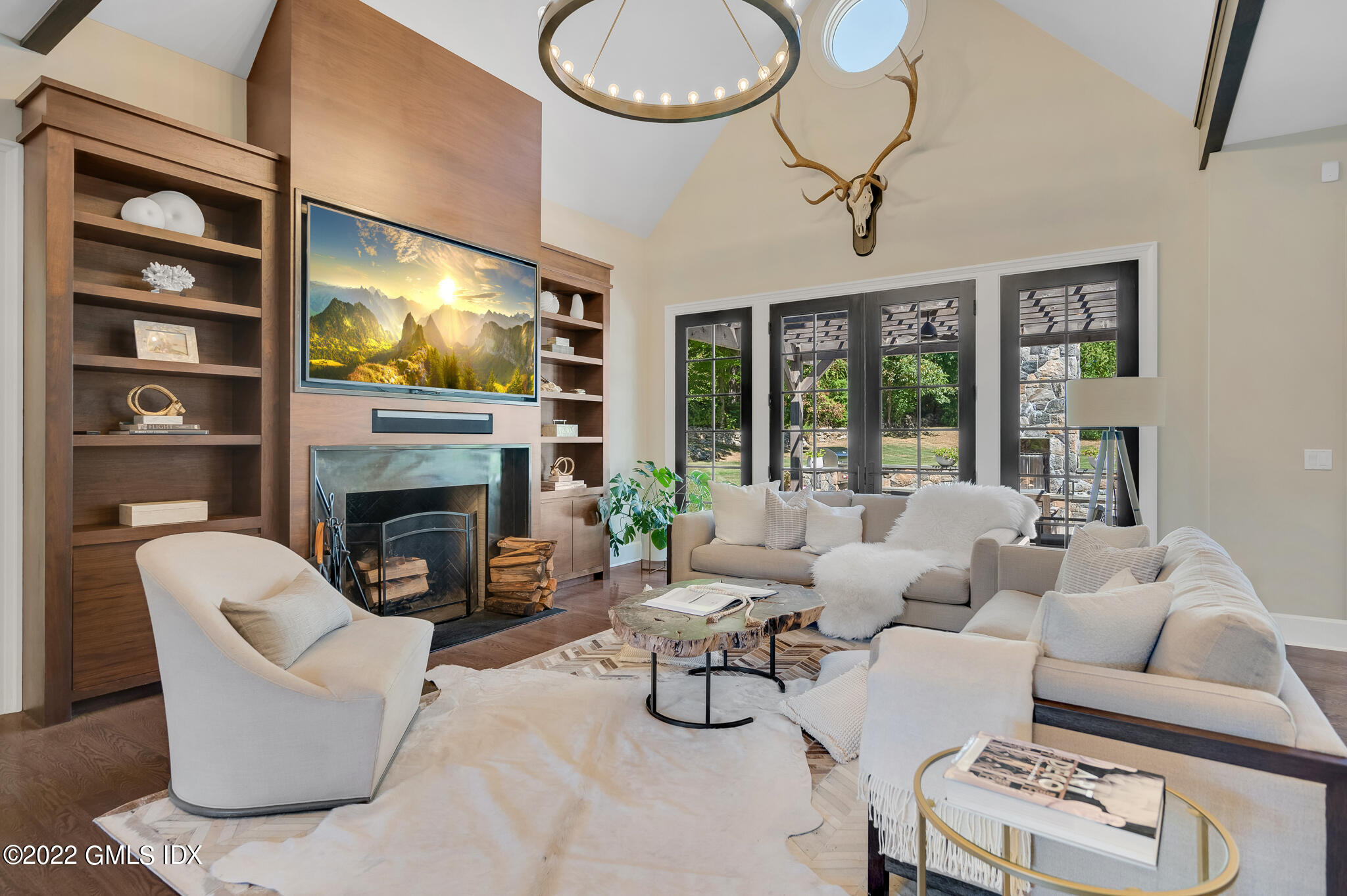 269 Riversville Road Greenwich, CT 06831 - Photo 6 of 55 a living room with furniture a flat screen tv and a fireplace